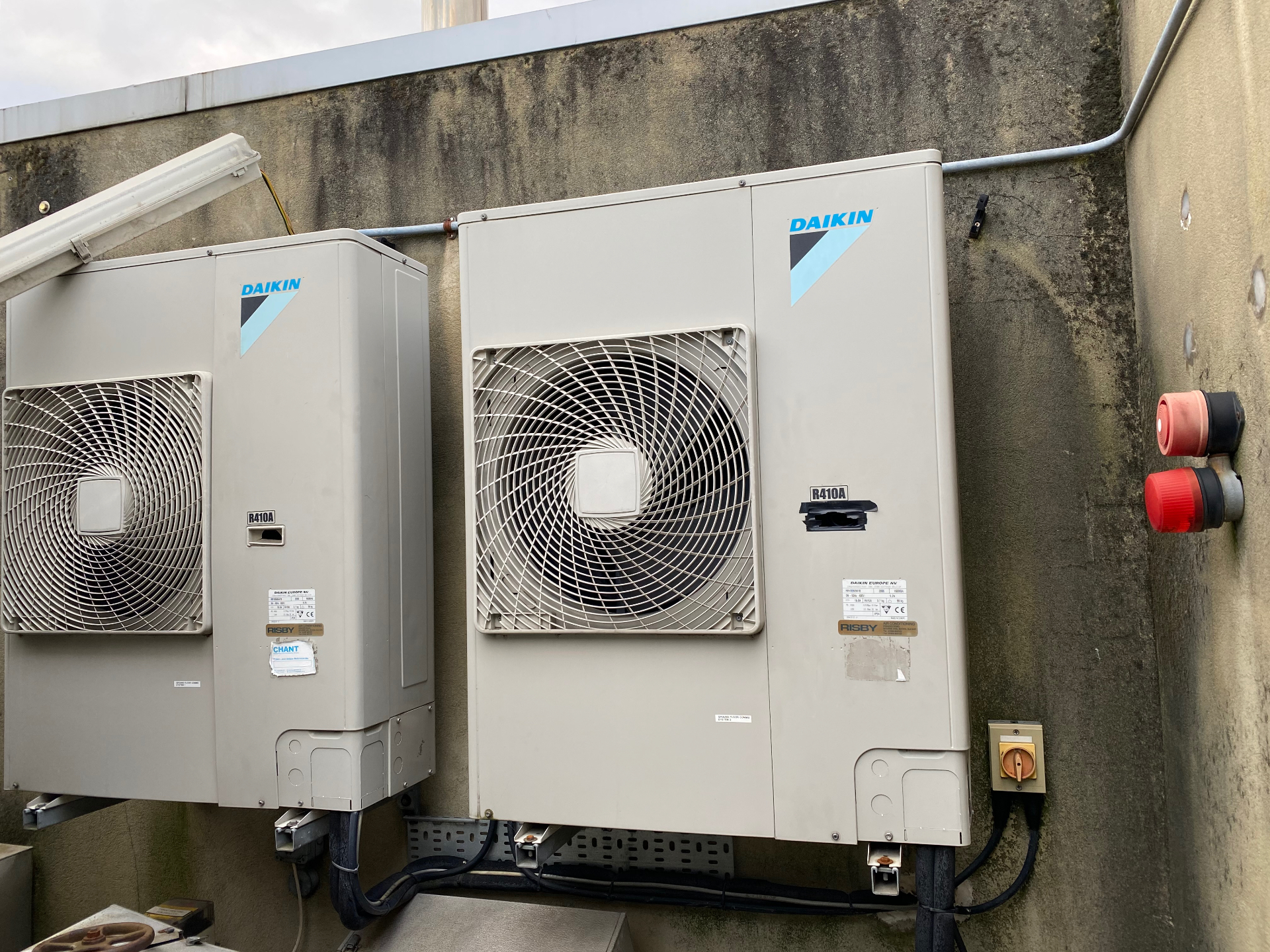 Twin Daikin condenser units with isolators on a rear elevation